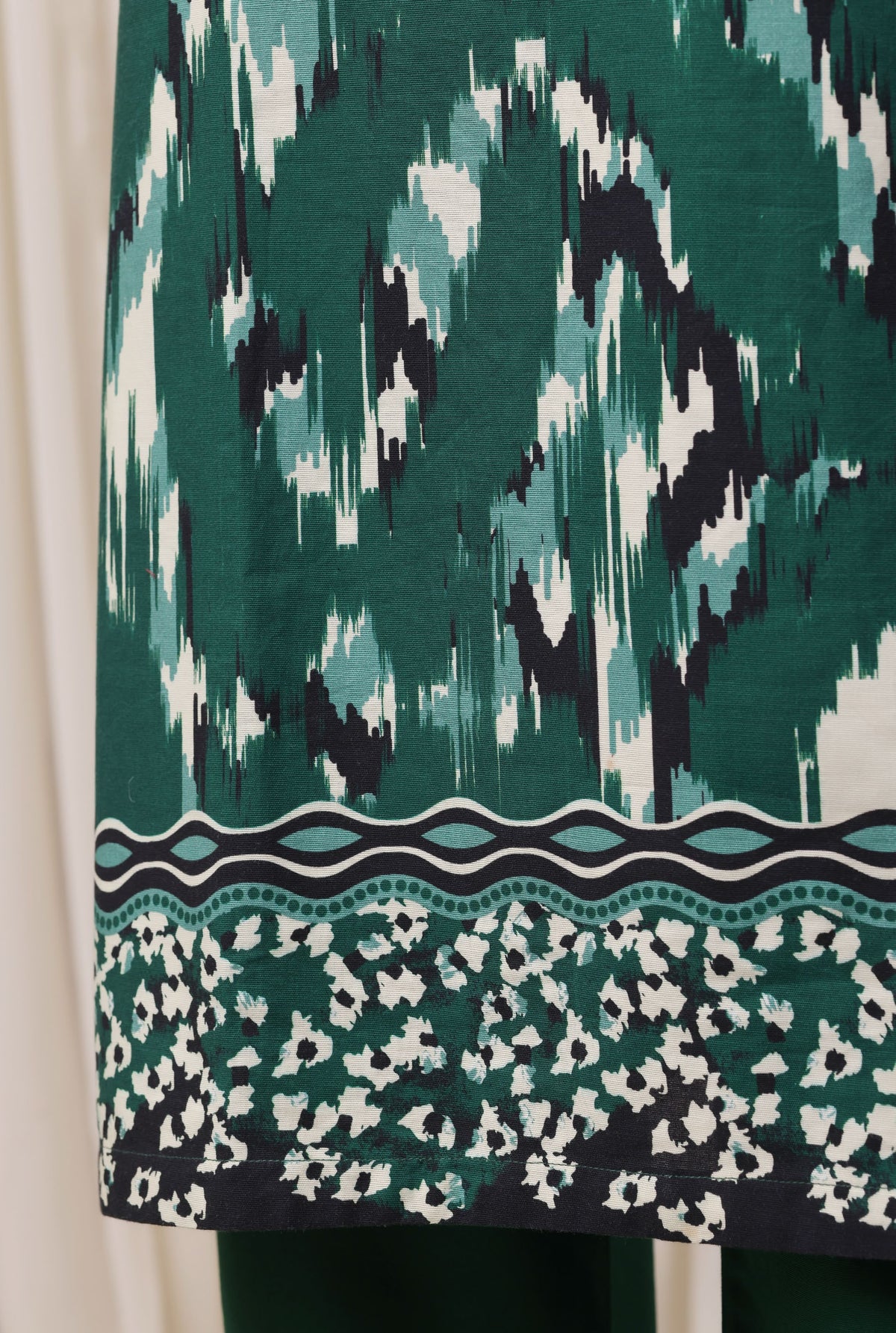 Sada Bahar emerald green suit fabric and hem detail